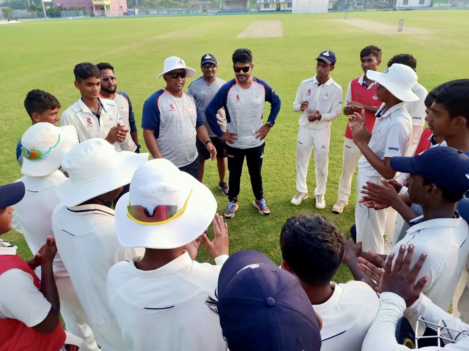 Match-day team talk with players in whites